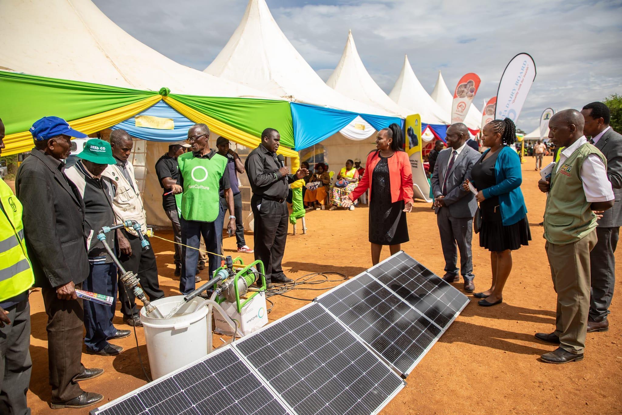 Farmers examining modern irrigation equipment